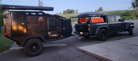 Jeep Gladiator towing an Off Grid Expedition 2.0 overland trailer, ready for your next off-road RV rental adventure.