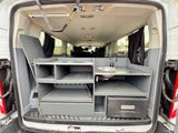 RV rental camper van's custom kitchen features a sink, faucet, shelves, drawers, & folding table for travel convenience.