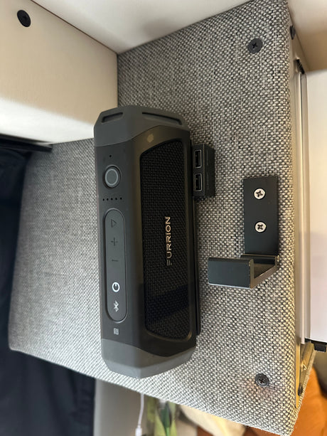 Furrion portable speaker & USB charging hub mounted in an RV rental. Ideal for music & device charging while traveling.