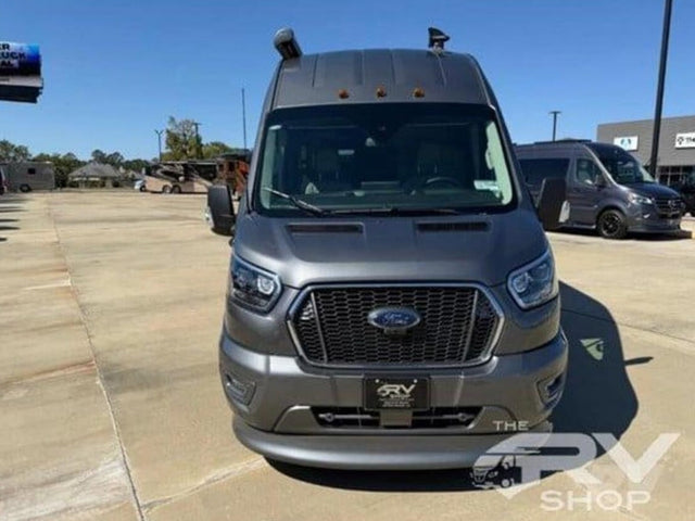 Front view of a dark gray Ford Transit rv rental camper van