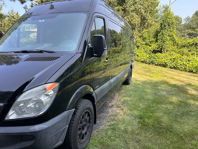  perfect for RV rental adventures. Parked on an asphalt driveway.|Inside an RV rental van: multi-person seating — photo 5