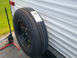  and a white countertop.|Clean RV rental sleeping area features a plastic-wrapped mattress