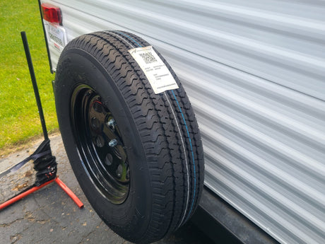  and a white countertop.|Clean RV rental sleeping area features a plastic-wrapped mattress