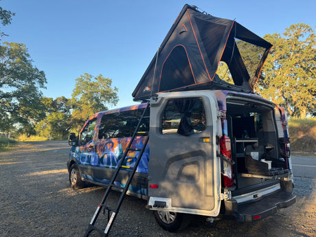 Custom camper van rv rental with pop-up rooftop tent and rear kitchen setup for your next adventure.