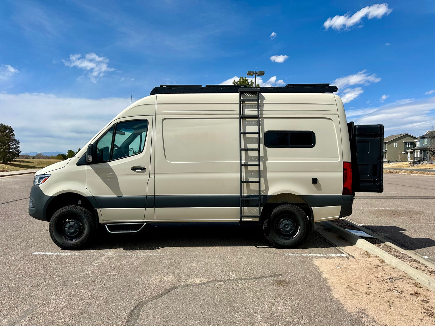  ready for adventure under a blue sky.|Stylish beige Mercedes-Benz Sprinter camper van — photo 3