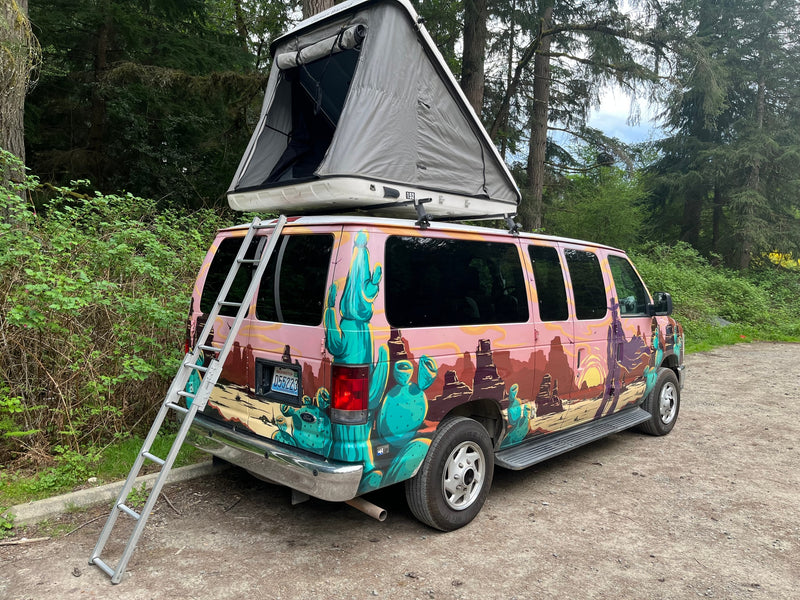 Colorful custom camper van with a rooftop tent, ideal for an rv rental adventure in nature. — photo 5