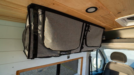 Maximizing space in this rv rental campervan with an overhead fabric storage bag, ideal for organizing your adventure essentials.