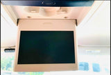 Inside an RV rental: a flip-down overhead monitor for entertainment. Enjoy road trip movies!