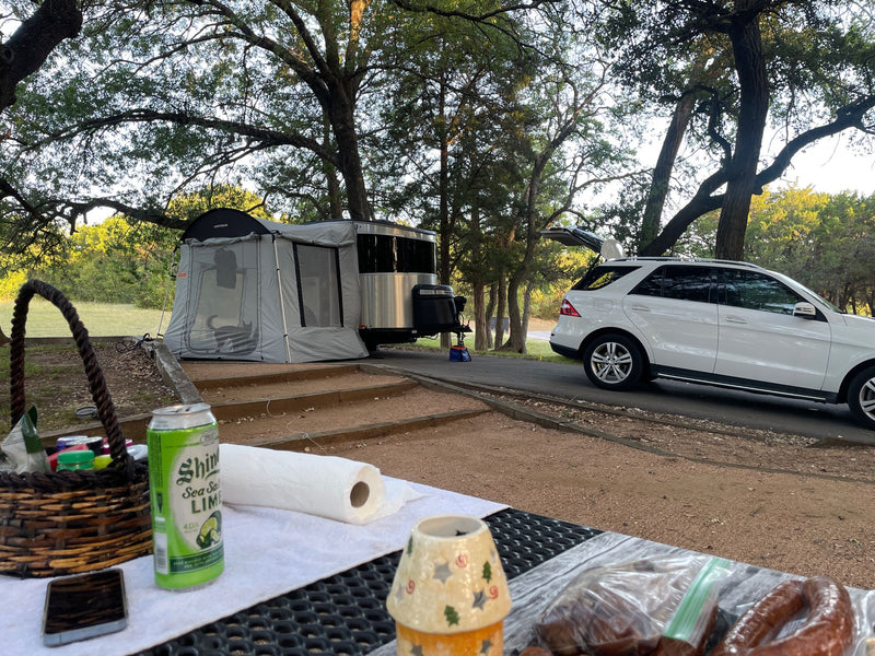  and large windows.|Inside this cozy RV rental: a plush bed with white linen — photo 9