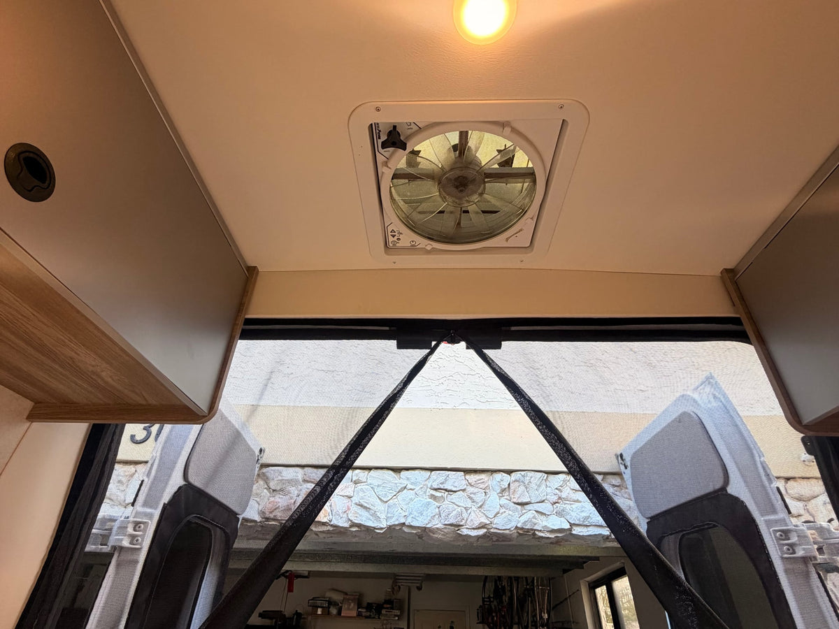  and a view of the street through the windshield.|Inside an RV rental: full kitchen with sink & fridge — photo 10