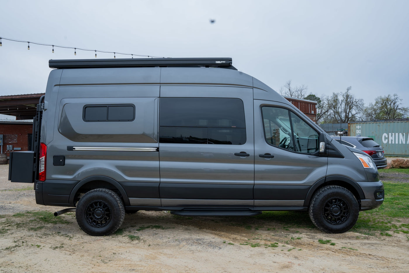  and all-terrain tires.|A dark gray Ford Transit van converted into a camper — photo 5