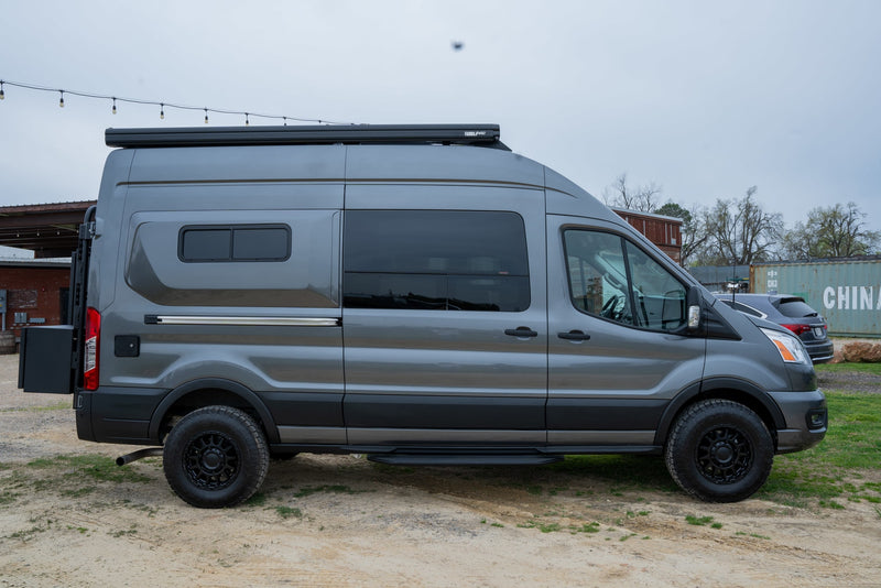  and all-terrain tires.|A dark gray Ford Transit van converted into a camper — photo 5