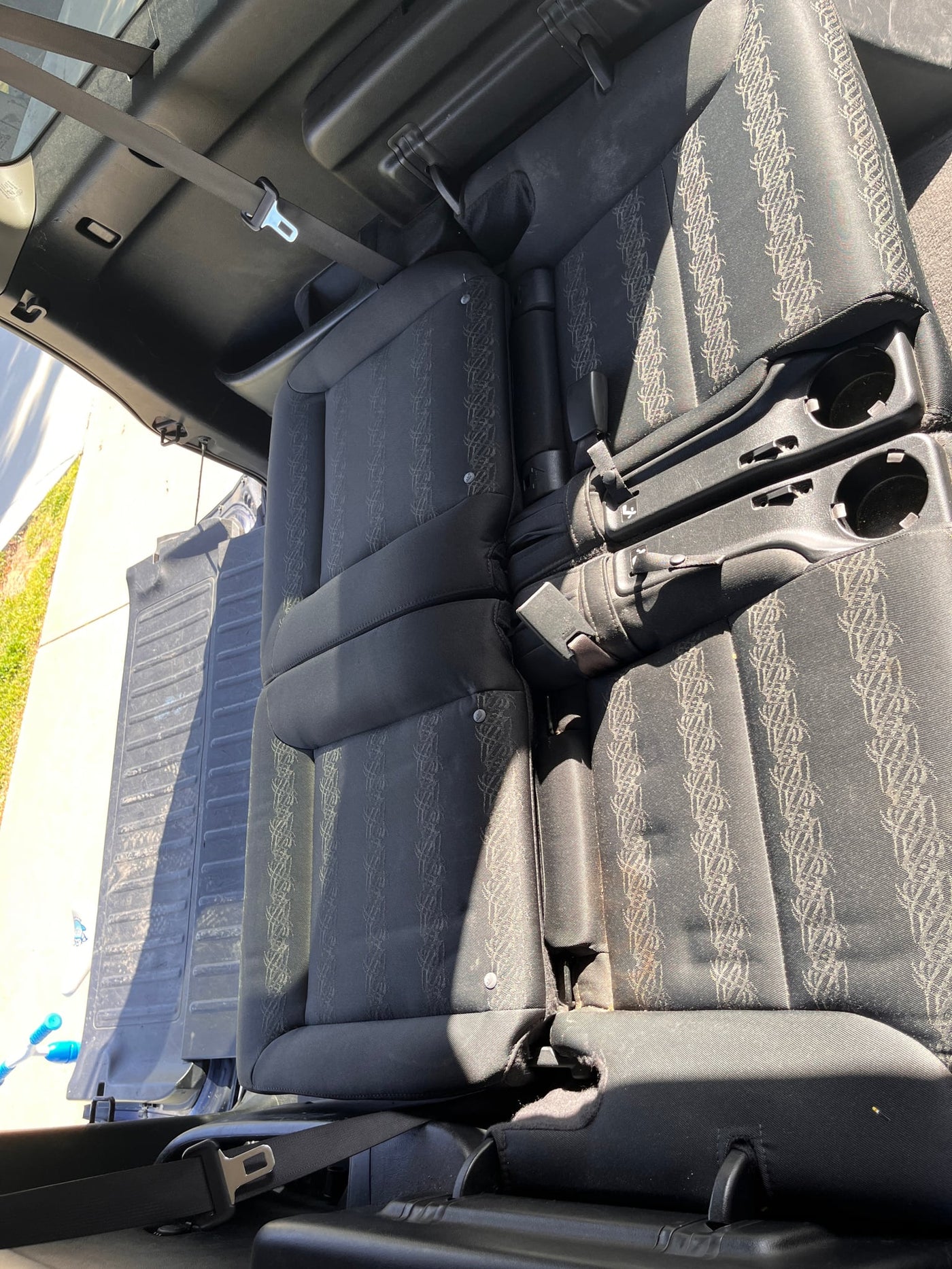  showing floor dimensions near a seat base. Perfect for planning.|Versatile vehicle interior with seats folded for cargo; perfect for an RV rental.|Spacious RV rental interior: dark fabric seats measured 7'1" long by a phone app — photo 12