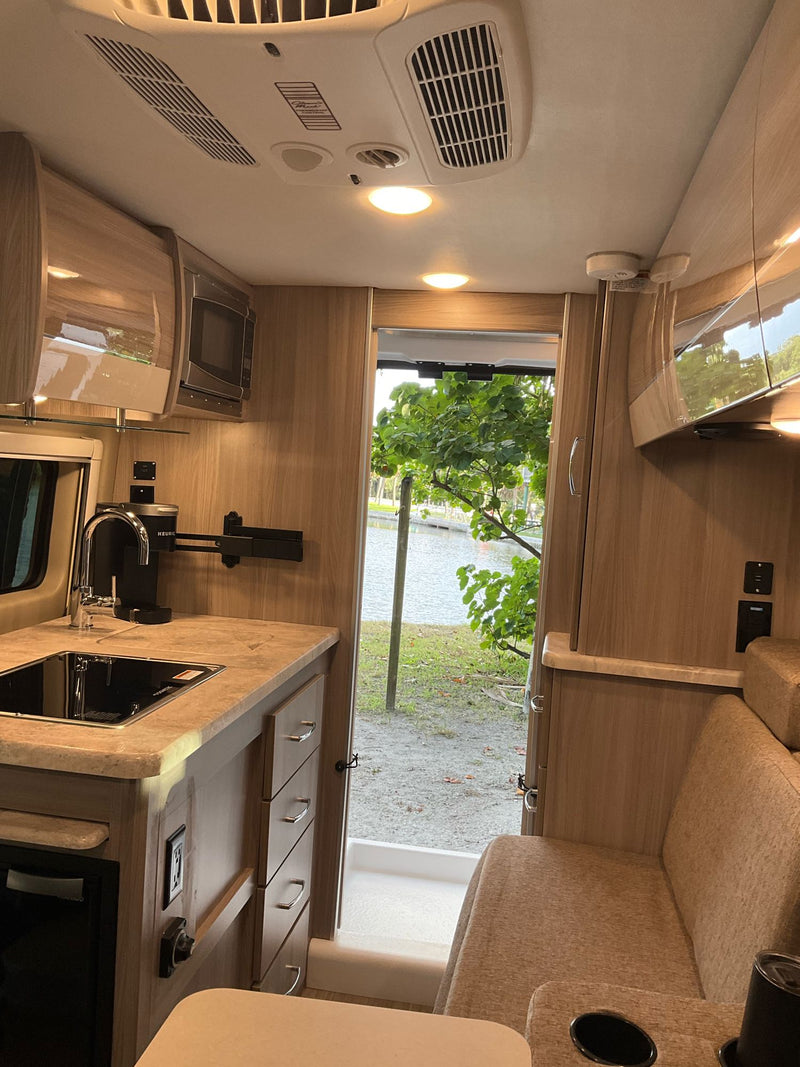  and mirror for convenient travel.|An RV rental with its rear doors open — photo 9