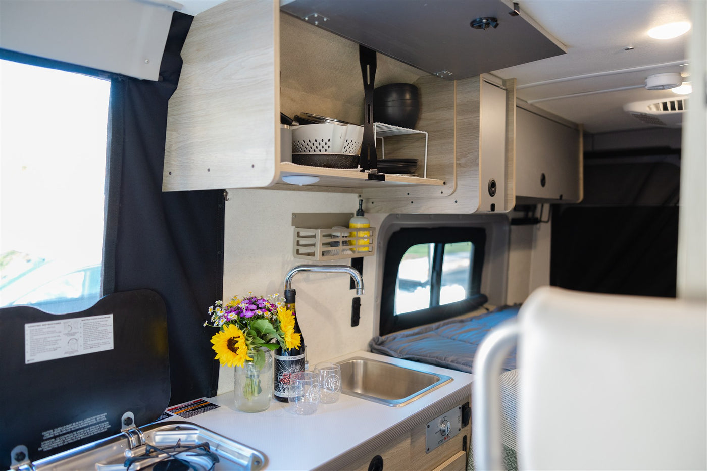  parked by scenic hills. Your road trip adventure awaits!|Spacious white camper van rv rental with open doors — photo 16