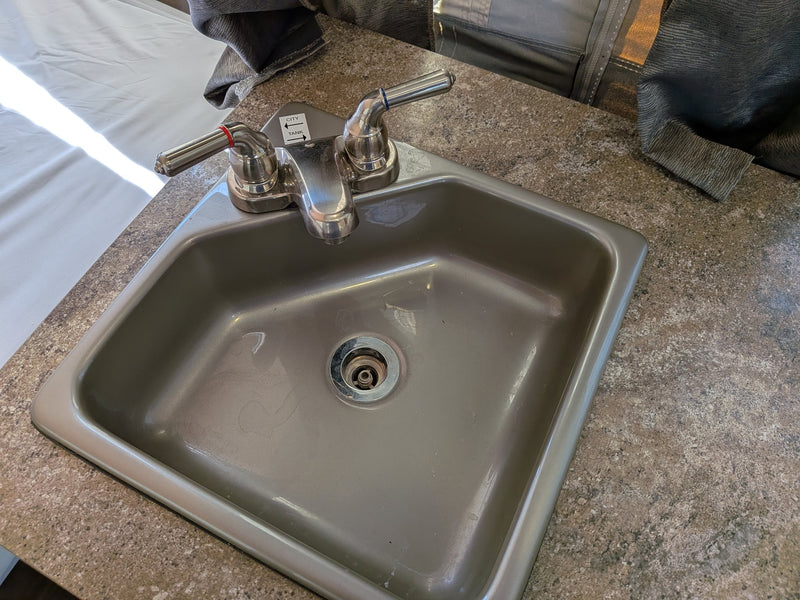  parked on a concrete driveway.|RV rental: Inside a pop-up camper showing a bed — photo 15