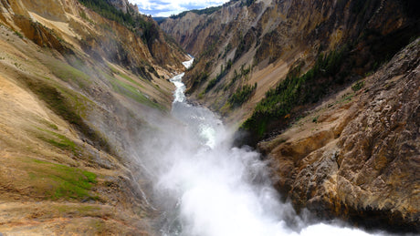 Explore Yellowstone's majestic Grand Canyon and misty Lower Falls, a perfect RV rental adventure.