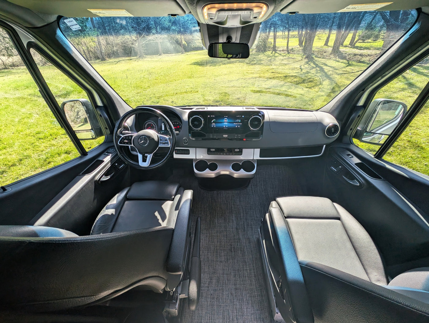  ready for adventure.|Rear view of a silver RV rental van with wide open doors revealing its interior and a bike rack — photo 4