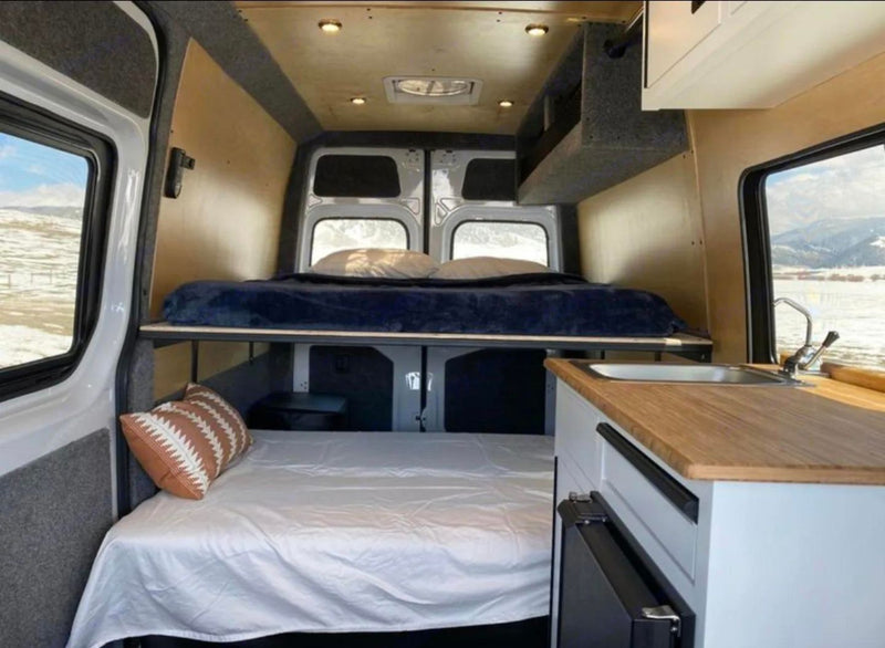  on a scenic wooden bridge with metal trusses.|Cozy rv rental van interior featuring bunk beds — photo 5