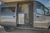 Inside this gray RV rental camper van, an open side door reveals a screen, sink, and compact kitchen setup.