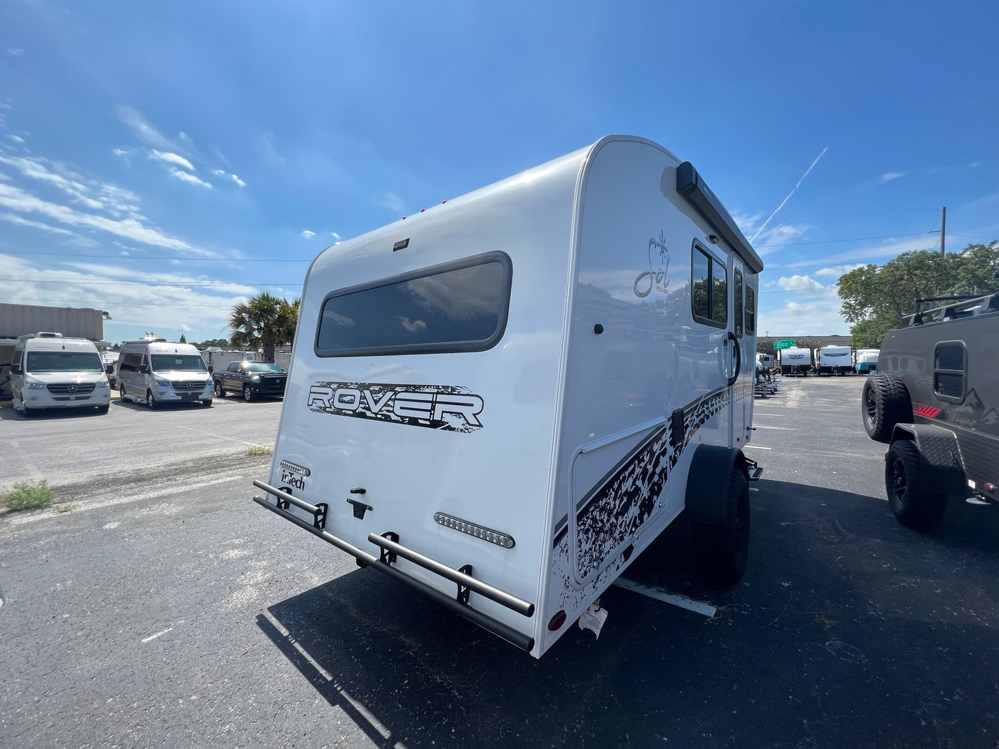  and large windows.|A modern rv rental interior showcasing a compact kitchen — photo 9