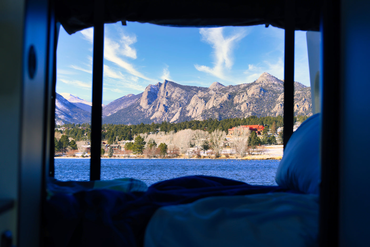 Wake up to stunning Rocky Mountain views from your RV rental! Lake and snow-dusted peaks framed by your cozy mobile home.
