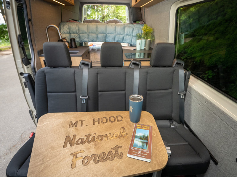 Cozy RV rental interior featuring a Mt. Hood National Forest table. Ideal for van life adventures & park exploration. — photo 5
