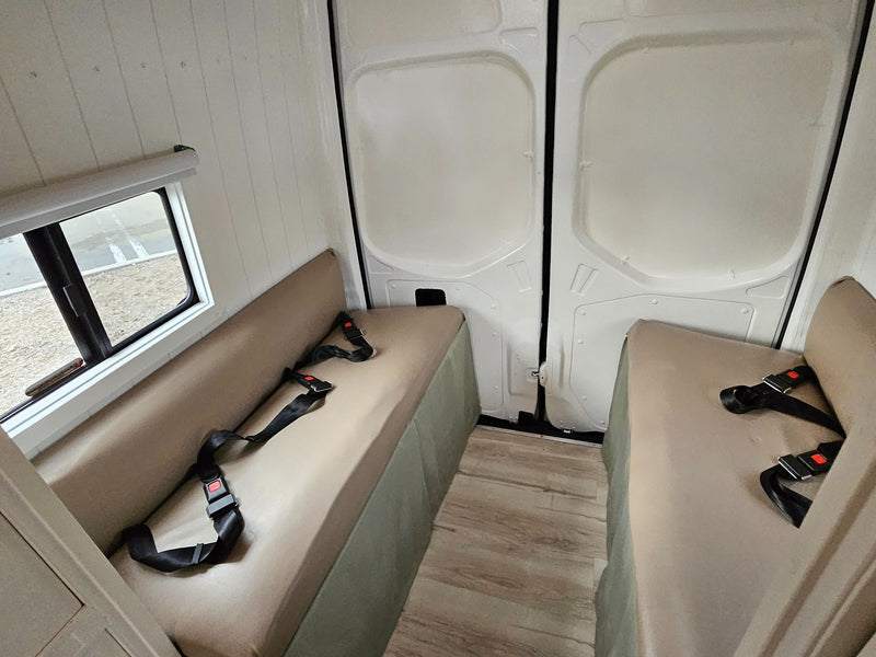  fridge) and cozy bench seating.|Compact RV rental bathroom with a shower on the left — photo 7