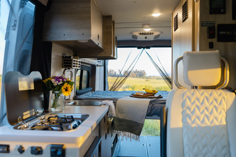  dashboard and mountains ahead are clear.|Cozy RV rental interior at sunset with wine — photo 18