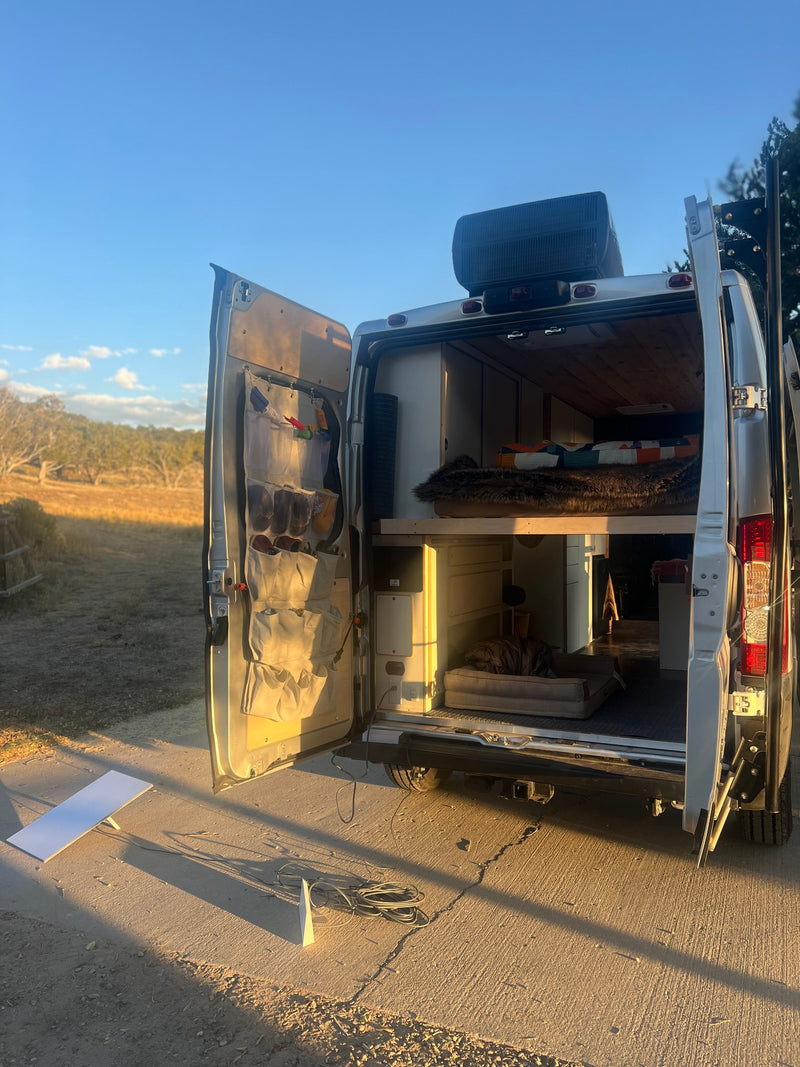 Explore the outdoors with this cozy RV rental! Inside, a comfy bed, dog bed, and organized storage await your next adventure. — photo 7