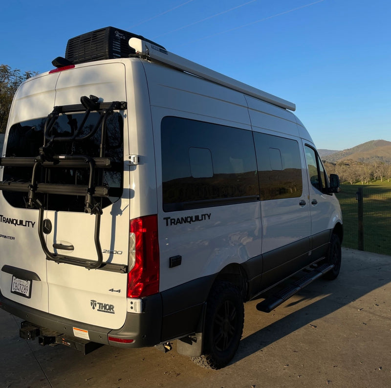  hilly backdrop.|White RV rental camper van parked with open doors — photo 5