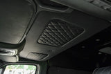 Inside an RV rental: a plush, black diamond-quilted ceiling, sleek overhead console, and front visor.