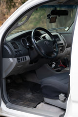 Inside this **rv rental** truck/SUV, the driver's area shows the dashboard, steering wheel, climate controls, and GPS.