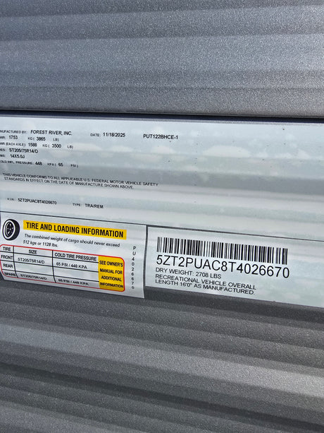 Essential RV rental info: VIN 5ZT2PUAC8T4026670, tire pressure (65 PSI), cargo & dry weight, and length 16'0".