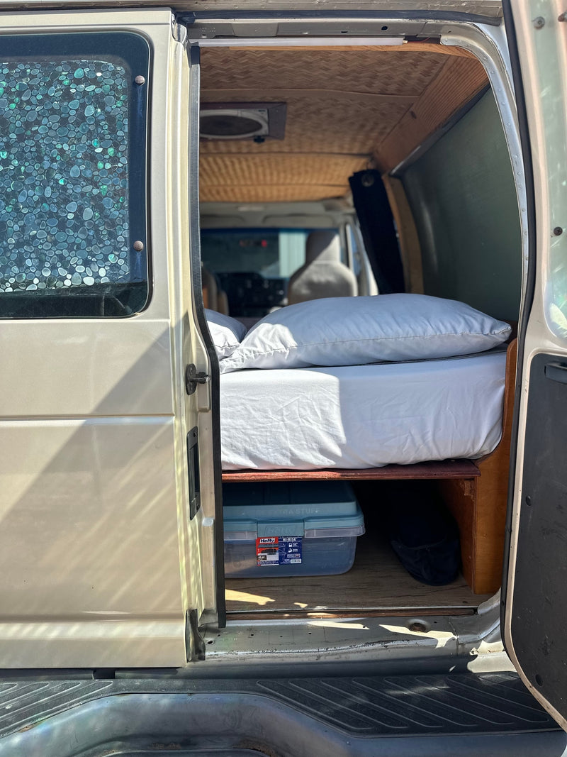 Cozy RV rental interior: bed, under-bed storage, bamboo ceiling. Perfect for your van life adventure. — photo 14