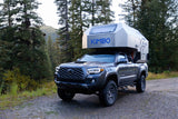 This dark gray Toyota Tacoma with a Kimbo truck camper is ideal for your next RV rental & overland camping trip.