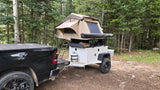 Off-road camping setup with a pickup truck & trailer, featuring a deployed rooftop tent. A unique alternative to an rv rental.