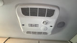 RV rental essential: Ceiling AC unit featuring Coleman-Mach thermostat control, vents, and comfort knobs for a pleasant journey.