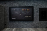 RV rental interior: An Ecoflow AC/DC Smart Distribution Panel for power management, alongside an electrical outlet.