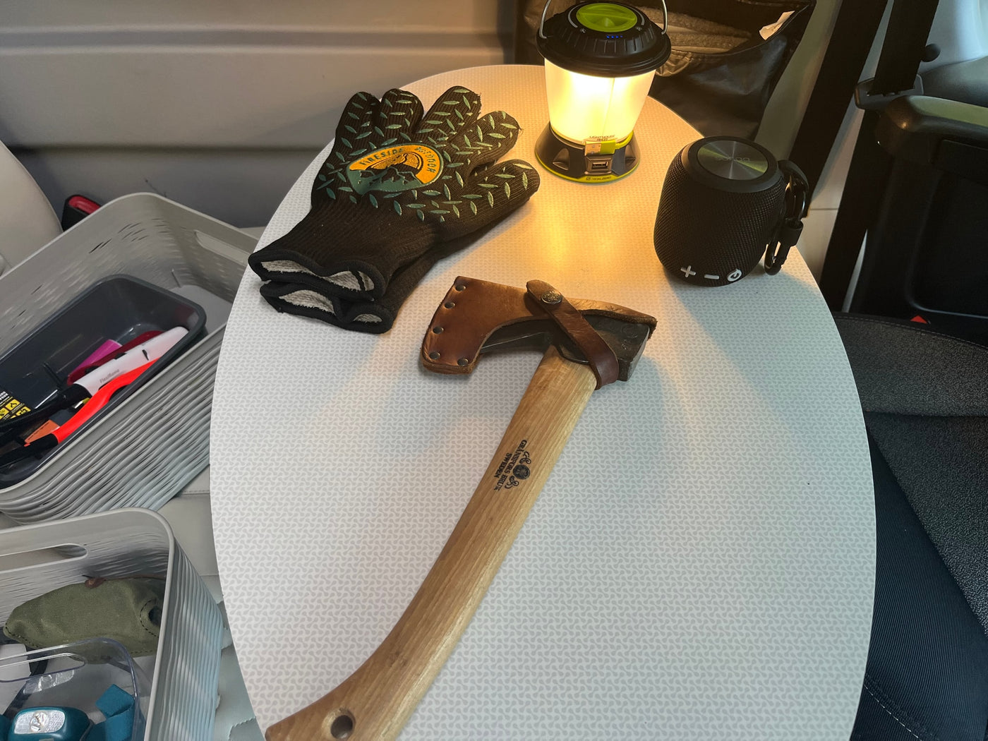 Essential rv rental camping gear: axe, lantern, speaker, gloves, and organized storage. Ready for adventure! — photo 16