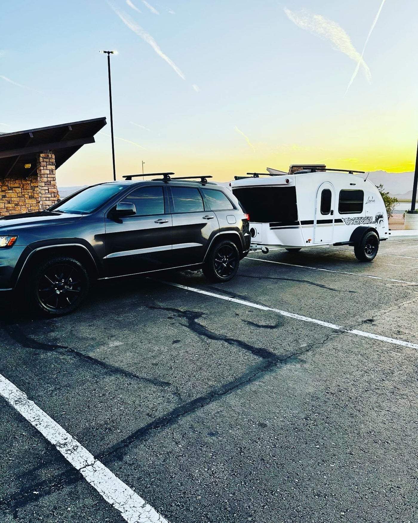  and kayak on top for outdoor fun.|RV rental by a lake at sunset. A white camper — photo 5