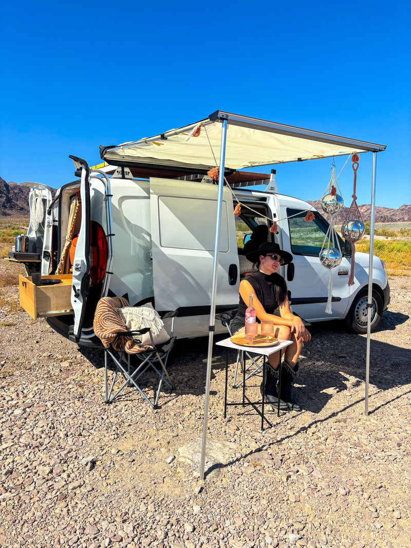  and smart under-bed storage for van life adventures.|View inside a stylish RV rental van conversion: comfy orange bed — photo 9
