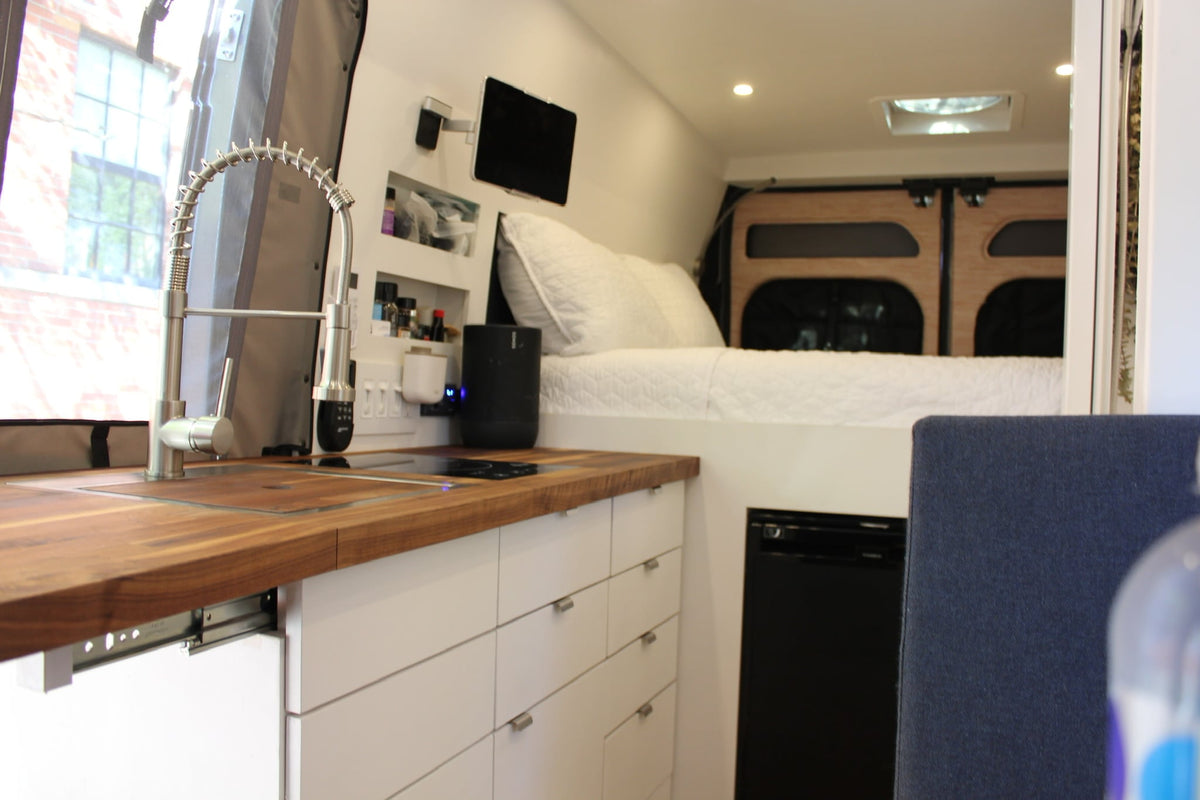 and induction cooktop on a wood counter.|Unique bear figurine on table in a cozy RV rental interior — photo 17