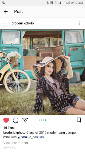 Teen model @camille_casillas, in a straw hat, poses by a yellow bike & vintage teal RV rental. Class of 2019 photo shoot!