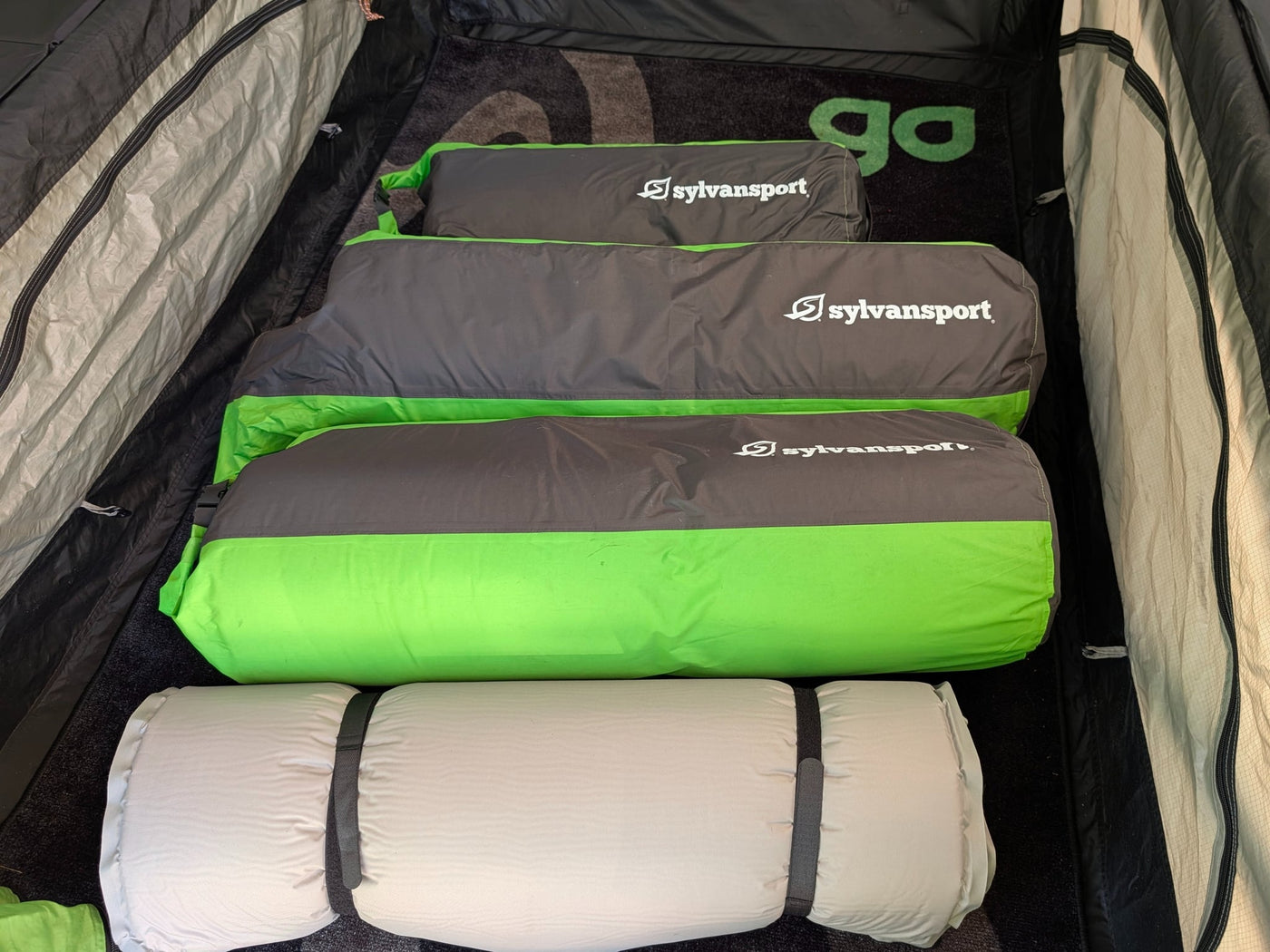  with a window and zippered entry for comfortable outdoor camping.|SylvanSport green RV rental tent/awning features a clear window for enhanced camping views.|Bright green SylvanSport tent — photo 14
