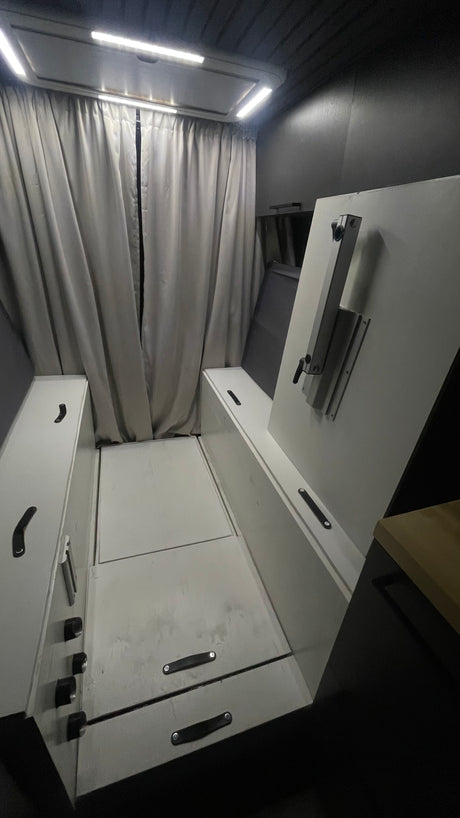 Explore this RV rental's functional interior: convertible bed, side storage, and privacy curtains. Bright LED lighting for a compact space.