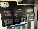 Essential RV rental control panel: solar, water, battery, and bed lift system displays/switches for camper operation.