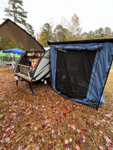 Autumn camping with an rv rental: a compact teardrop trailer featuring an open kitchen and attached screened room.