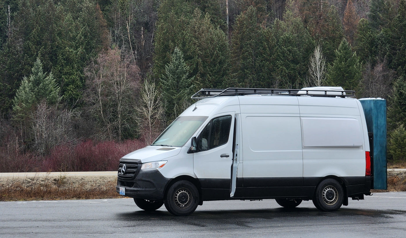 White Mercedes Sprinter camper van, a great RV rental, parked in a forest. Equipped for adventure travel. — photo 3