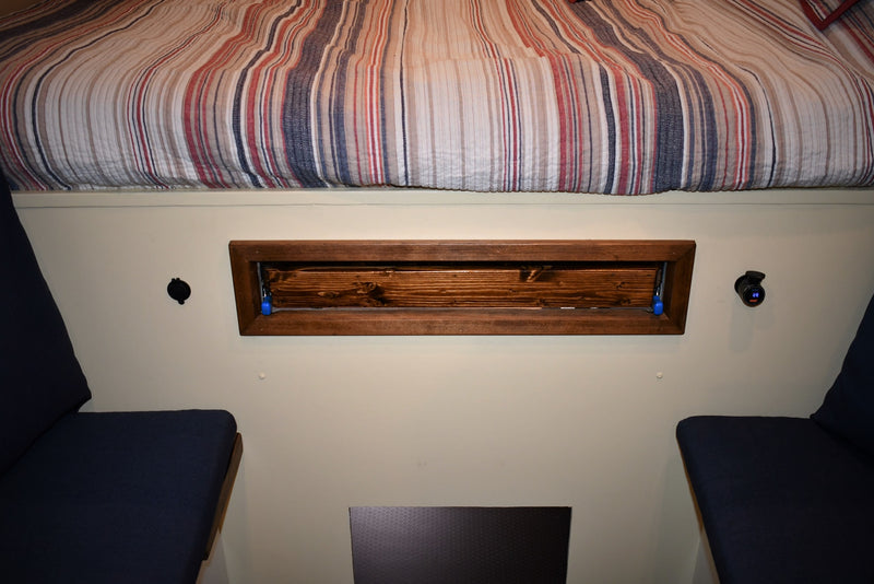  ideal for your next RV rental. Parked outdoors with an awning visible on the roof.|RV rental van's front cabin: driver & passenger seats — photo 14